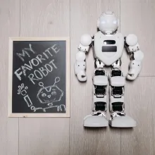 Roboter neben Kreidetafel